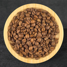 Wooden bowl filled with coffee beans on a dark background