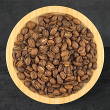 Coffee beans in a wooden bowl on a dark background